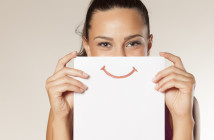 happy and smiling girl with a smile painted on paper