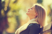 Young happy woman enjoying fresh air in autumn, intentionally toned.