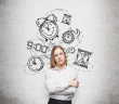 young pretty businesswoman thinking about time, in two minds, several models of clocks drawn behind. A concept of a value of time in business. Concrete wall at the background