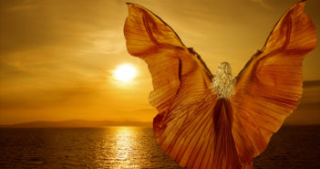 Woman with butterfly wings flying on fantasy sea sunset, relaxation meditation concept